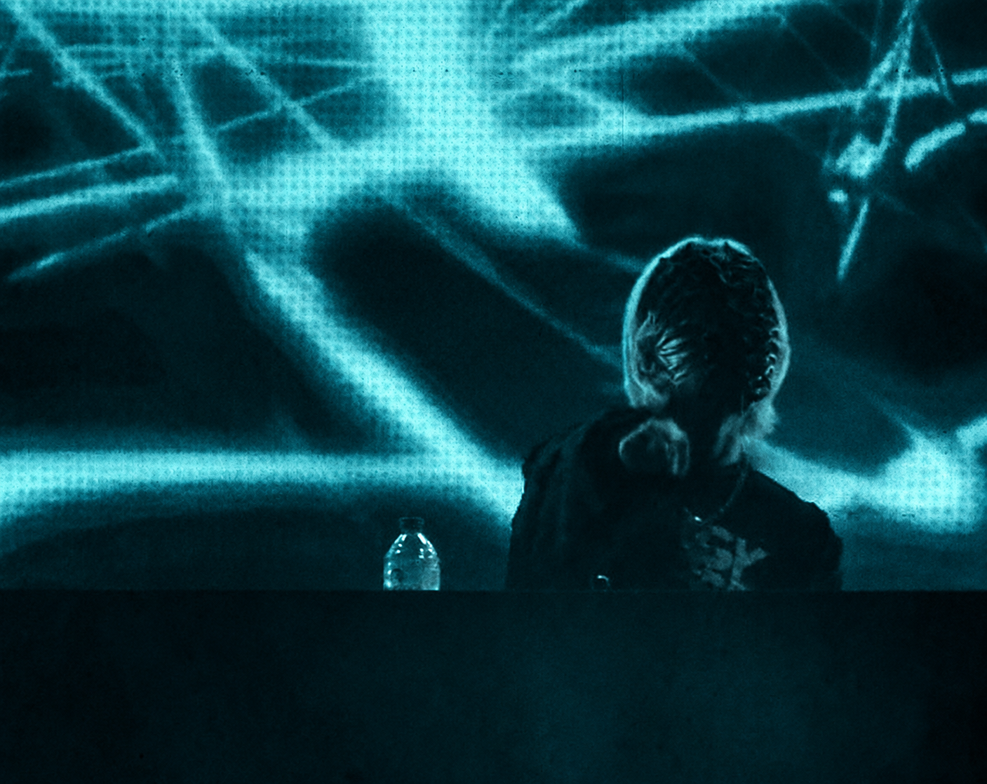 A performer surrounded by lights on stage.